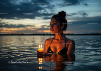 Woman in Black Bikini with Candles Floating in Lake at Sunset