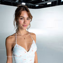 Young Woman in Floral Dress Posing Confidently in Studio