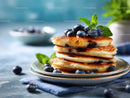 Stack of Fluffy Pancakes with Blueberries and Mint Garnish