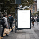 Empty city bus stop billboard on busy urban street