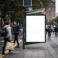Empty city bus stop billboard on busy urban street