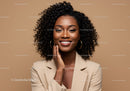 Beautiful African American Woman with Curly Hair and Warm Smile in Studio