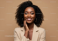 Beautiful African American Woman with Curly Hair and Warm Smile in Studio