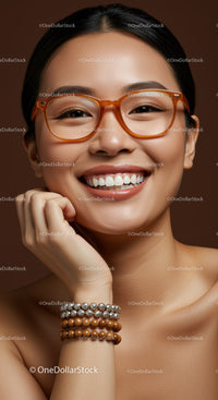 Happy young woman wearing orange glasses and jewelry