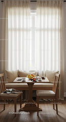 Bright Sunlit Kitchen with White Curtains and Cozy Dining Area