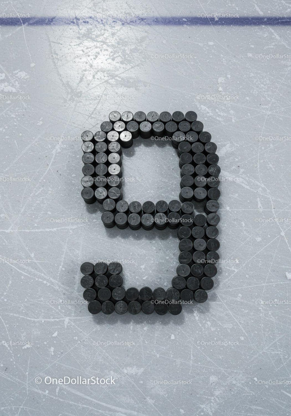 Number Nine Formed From Hockey Pucks on Ice Rink