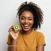 Happy Woman Smiling While Holding a Fresh Kiwi Fruit