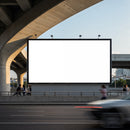Large blank billboard under urban overpass with passing traffic