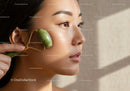Close-up of a Woman Using Jade Roller for Skin Rejuvenation
