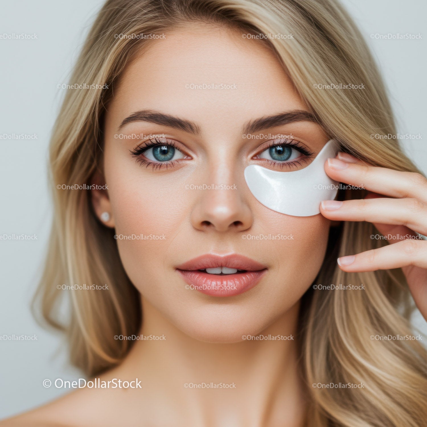 Close-up of a Beautiful Woman with Blue Eyes in Facial Treatment