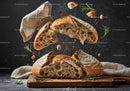 Rustic sourdough bread breaking apart with herbs