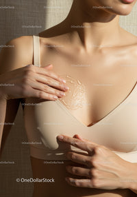 Close-up of a Woman Applying Moisturizer with Soft Skin and Nude Clothing