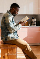 Man reading book calmly in a bright modern kitchen