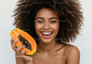 Joyful Woman Holding Fresh Papaya with Bright Smile in Studio