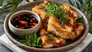 Crispy Fried Fish Fillets with Spicy Dipping Sauce and Fresh Herbs