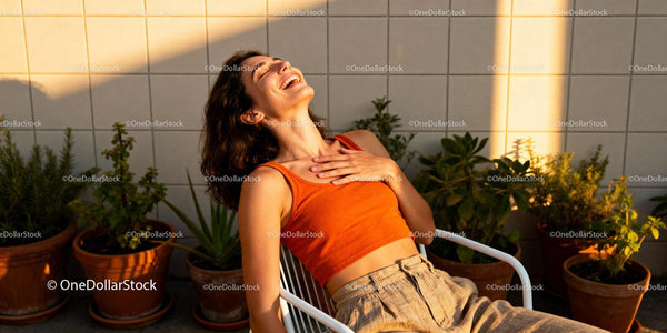 Joyful woman relaxing in sunlit garden terrace