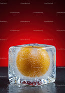 Frozen yellow fruit encased in clear ice cube