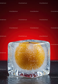 Frozen yellow fruit encased in clear ice cube