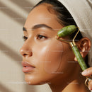 Close-up of a Woman Using a Jade Facial Roller for Skincare