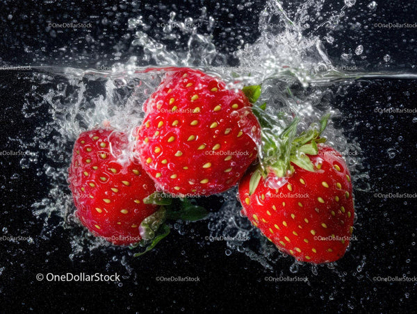 Close-Up of Fresh Ripe Strawberries Splashing into Water