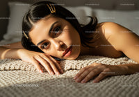 Elegant Woman Relaxing on Bed with Soft Lighting and Cozy Atmosphere