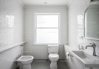 Modern White Bathroom with Tiled Walls and Natural Light