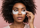 Young Woman Applying Under Eye Patches for Skin Care Moisturization
