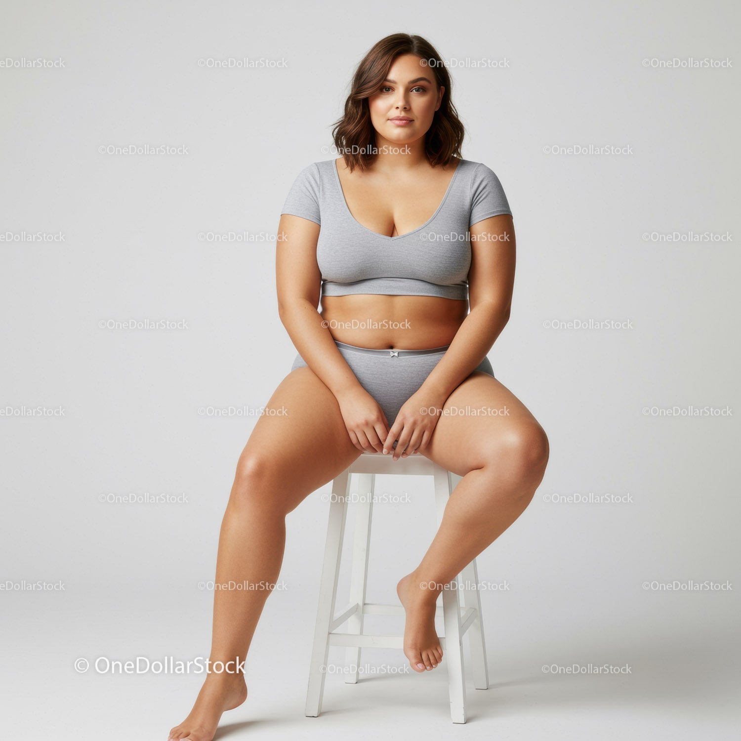 Plus Size Woman in Gray Lounge Wear Sitting Confidently on a Stool