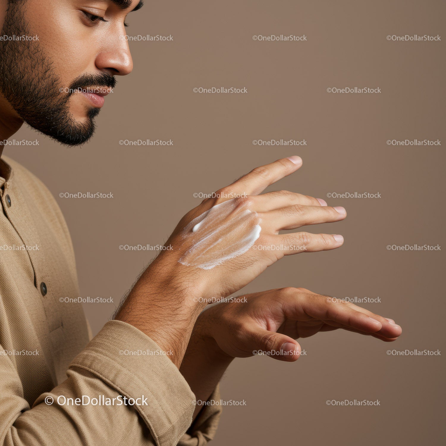 Male Man Applying Lotion or Skincare Product on Hand for Grooming