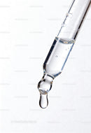 Close up of clear serum drop from glass pipette