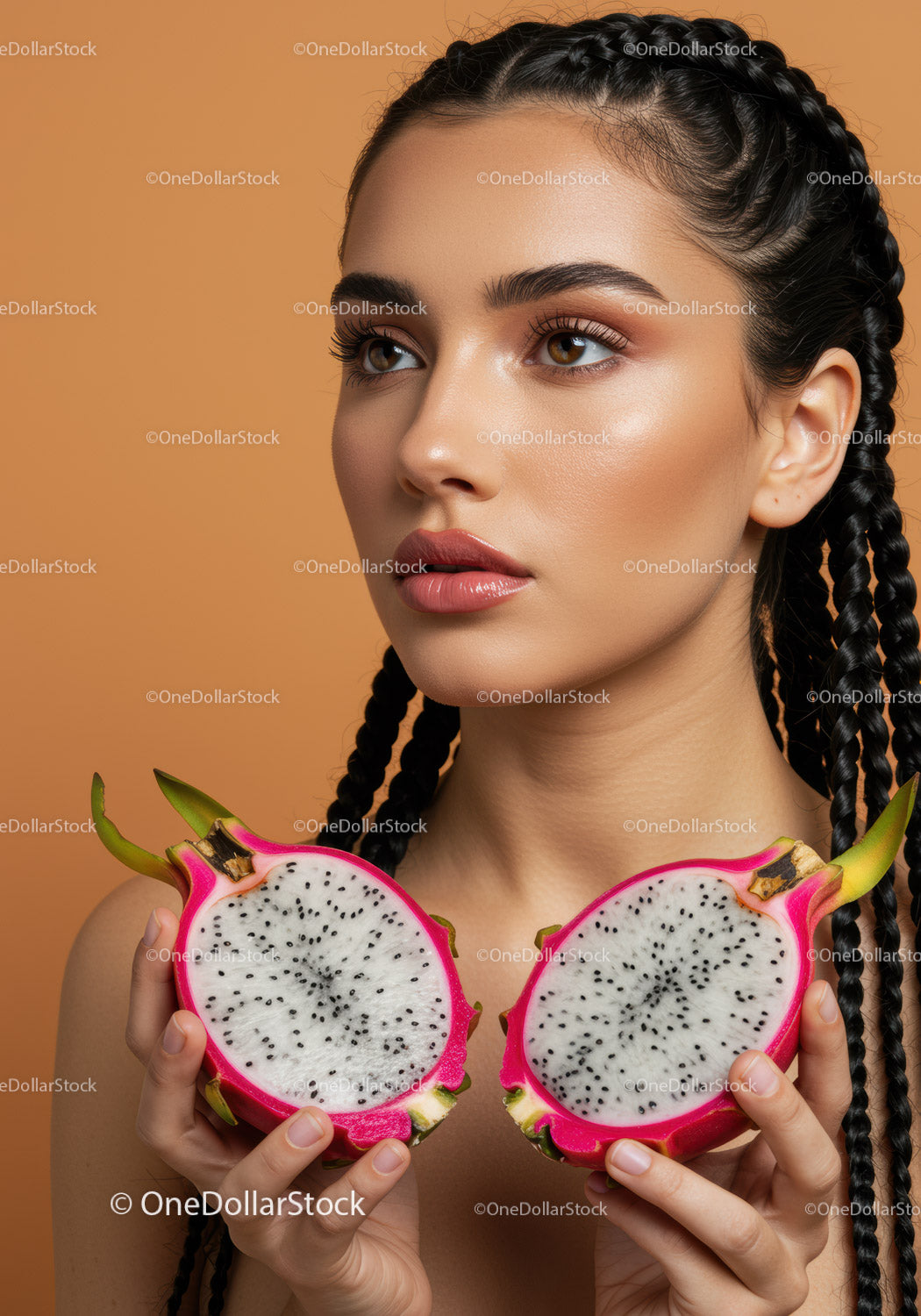 Close-up of a Woman Holding Halved Dragon Fruits in Bright Setting
