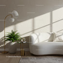 Bright modern living room with white curved sofa and greenery