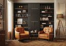 Cozy reading nook with leather armchairs and modern bookshelf
