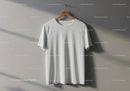 Plain white T shirt hanging on wooden hanger against wall
