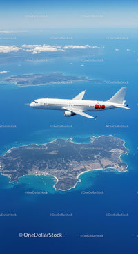 Aerial View of Commercial Jet Flying Over Tropical Island and Ocean