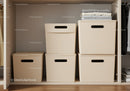 Home Closet with Beige Storage Bins and Folded Laundry