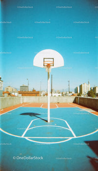 Urban Rooftop Basketball Court Under Clear Blue Sky