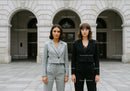 Two Businesswomen Standing Outside in Formal Suits in City Environment