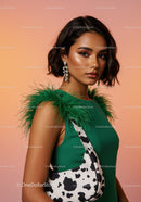 Elegant Woman in Green Dress with Cow Print Handbag and Feather Accessories