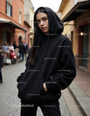 Fashionable Woman Wearing Black Hoodie in Urban City Street