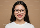 Portrait of a Happy Woman Wearing Black Round Glasses Against Beige Background