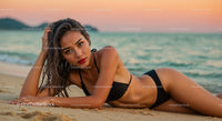 Glamorous Woman Relaxing on Beach at Sunset with Ocean View