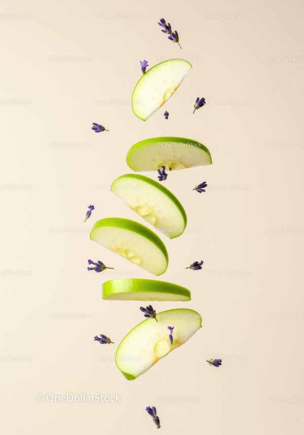 Floating green apple slices with delicate lavender buds