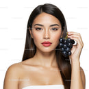 Elegant Woman with Long Dark Hair Holding Black Grapes High-Resolution Beauty Photo