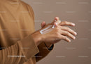 Close-up of Hand Applying Lotion with Moisturizing Effect