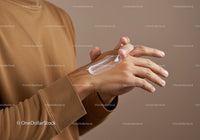 Close-up of Hand Applying Lotion with Moisturizing Effect