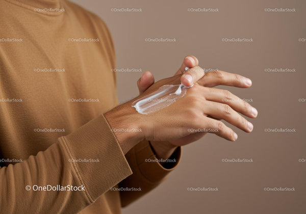 Close-up of Hand Applying Lotion with Moisturizing Effect
