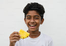 Young Boy Holding Fresh Pineapple with Joyful Smile During Summer
