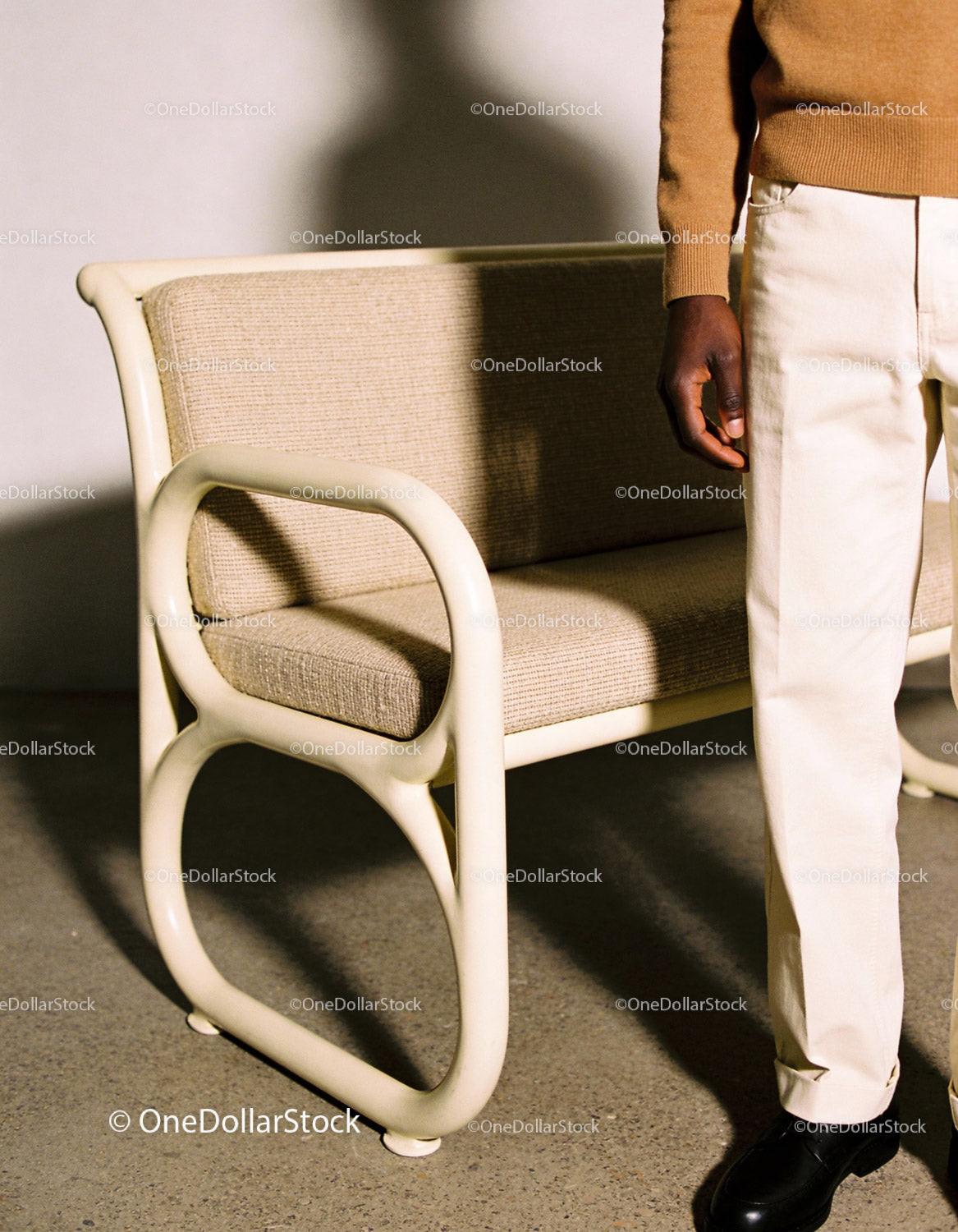 Man standing next to retro beige bench in casual outfit