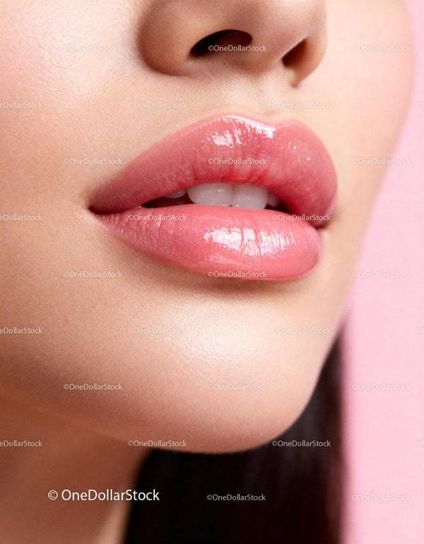 Closeup of glossy pink lips with smooth skin texture